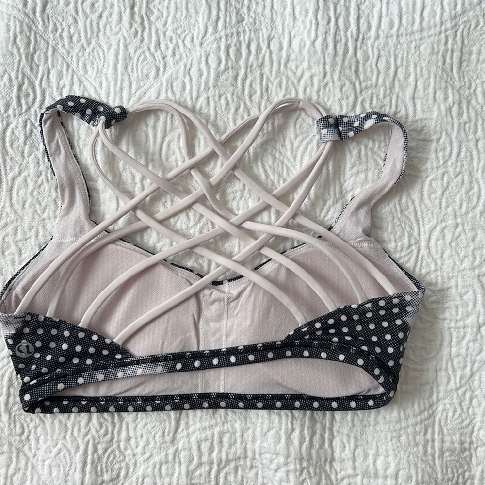 Lululemon free to be sports bra in light pink and dark blue polka dot size 4